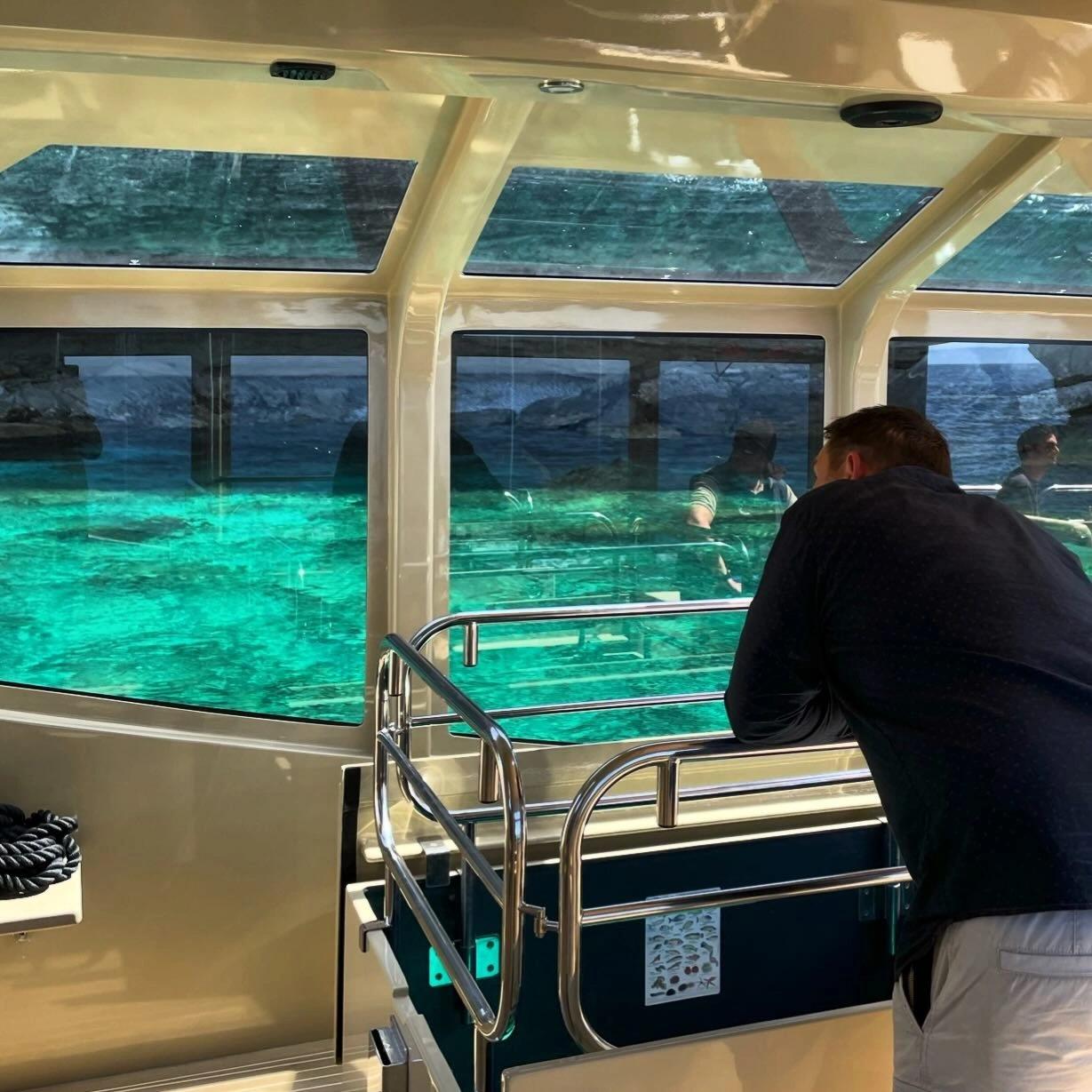 Vue sur l'eau turquoise depuis l'interieur d'un bateau vitré